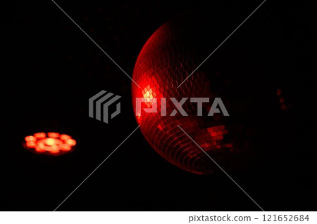 A Disco Ball Shining Red Light, Creating an Energetic Atmosphere Perfect for Celebrating A Disco Ball Shining Red Light, Creating an Energetic Atmosphere Perfect for Celebrating 121652684