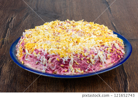 Multi-layer salad Herring under a fur coat made from chopped herring, beets, potatoes, carrots and eggs. 121652743