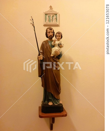 statue of a monk holding a baby statue of a monk holding a baby 121653078