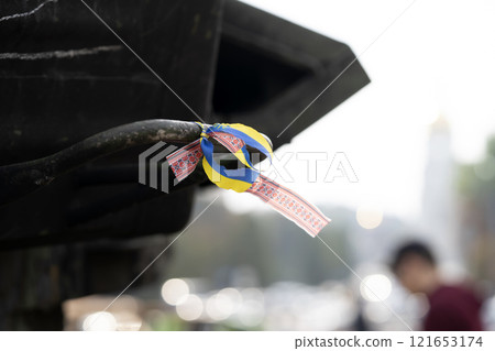 A ribbon with Ukrainian flag on the dark background. A ribbon with Ukrainian flag on the dark background. 121653174