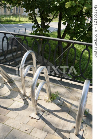 metal bicycle parking in business part of city or in park, gray colorful white-standing counter metal bicycle parking in business part of city or in park, gray colorful white-standing counter 121653248