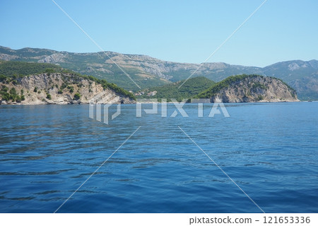 RT Dubovica Rocks near Buljarica and Svetac Rock, Montenegro. Stones inaccessible rocks. Flysch marine lithological layers. Adriatic Mediterranean sea blue water. Nature park Katici. District Budva 121653336