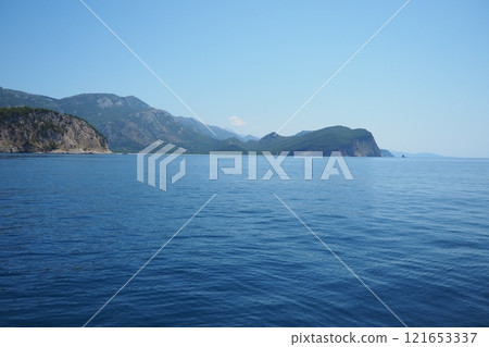 RT Dubovica Rocks near Buljarica and Svetac Rock, Montenegro. Stones inaccessible rocks. Flysch marine lithological layers. Adriatic Mediterranean sea blue water. Nature park Katici. District Budva 121653337