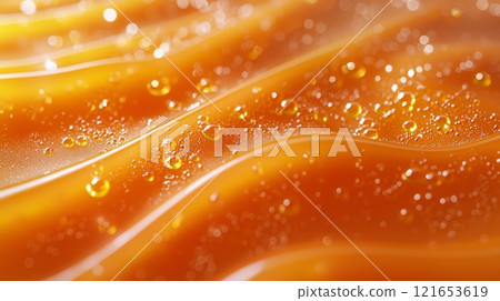 Orange liquid with droplets and wavy texture 121653619