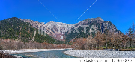 Panoramic view of the Hotaka mountain range and Azusa River in late autumn against a blue sky Panoramic view of the Hotaka mountain range and Azusa River in late autumn against a blue sky 121654870
