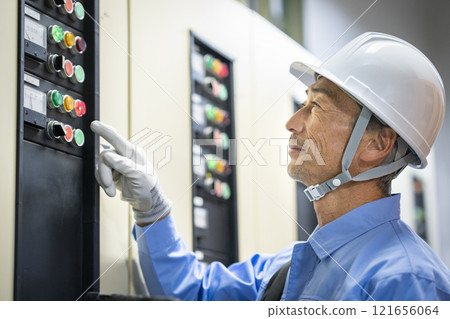 Building maintenance staff image: Profile of a worker inspecting electrical equipment Building maintenance staff image: Profile of a worker inspecting electrical equipment 121656064