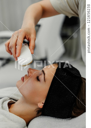 Woman receives facial treatment at a spa during a relaxing afternoon appointment Woman receives facial treatment at a spa during a relaxing afternoon appointment 121656238