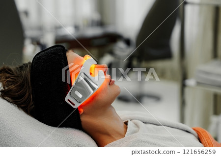 Relaxing facial treatment with innovative light therapy in a spa setting Relaxing facial treatment with innovative light therapy in a spa setting 121656259