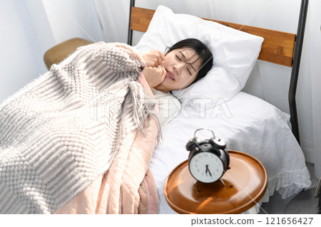 Young Asian woman looking distressed on the bed 121656427