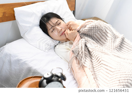 Young Asian woman looking distressed on the bed 121656431