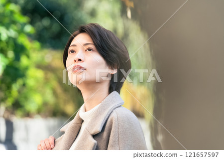 A woman walking outdoors 121657597
