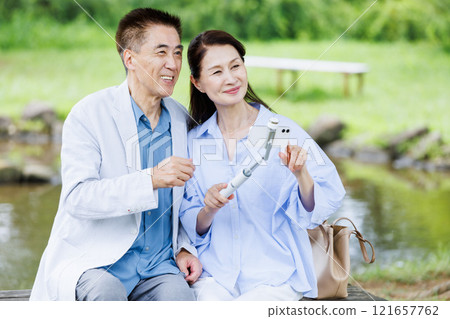 Senior couple taking a selfie with a smartphone Senior couple taking a selfie with a smartphone 121657762