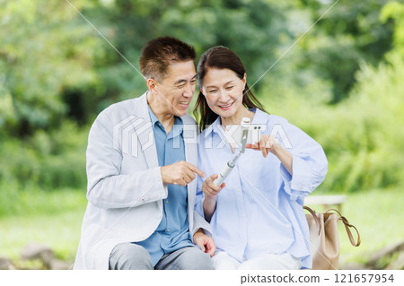 Senior couple taking a selfie with a smartphone Senior couple taking a selfie with a smartphone 121657954
