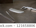 Measuring the dimensions of parts with calipers 121658806