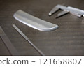 Measuring the dimensions of parts with calipers 121658807