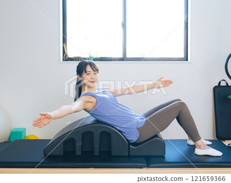 Woman doing machine pilates training 121659366