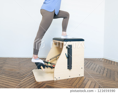 Woman doing machine pilates training 121659390