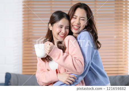Beautiful two Asian female LGBT lesbian embracing with love and romance , Positive mood and good moment with quality time at warmth place.LGBTQ+ Lifestyle Pride Month Beautiful two Asian female LGBT lesbian embracing with love and romance , Positive mood and good moment with quality time at warmth place.LGBTQ+ Lifestyle Pride Month 121659882
