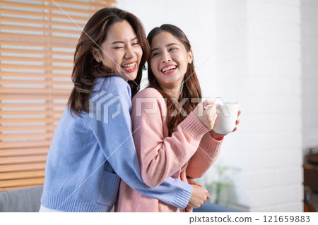 Beautiful two Asian female LGBT lesbian embracing with love and romance , Positive mood and good moment with quality time at warmth place.LGBTQ+ Lifestyle Pride Month Beautiful two Asian female LGBT lesbian embracing with love and romance , Positive mood and good moment with quality time at warmth place.LGBTQ+ Lifestyle Pride Month 121659883