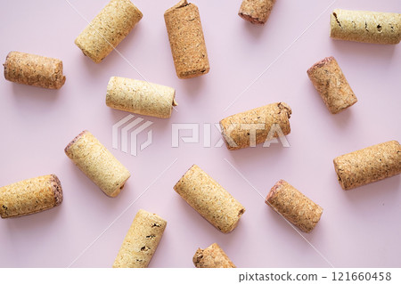Many used wine corks arranged on pink background. Many used wine corks arranged on pink background. 121660458