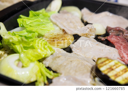 Delicious home-cooked food, grilled meat on a hot plate Delicious home-cooked food, grilled meat on a hot plate 121660785