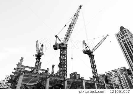 Black and white photo, View of cranes above steel structure for building construction in Taiwan. 121661097