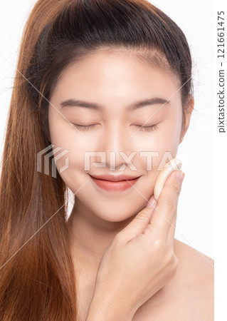 Content young Asian woman gently touching her face with eyes closed on a white background 121661475