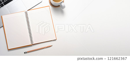 Top view of laptop, lined notebook and cup of coffee on a clean white surface Top view of laptop, lined notebook and cup of coffee on a clean white surface 121662367
