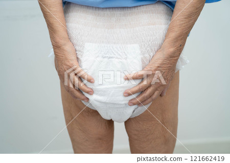 Asian senior woman patient wearing adult incontinence diaper pad in hospital. 121662419