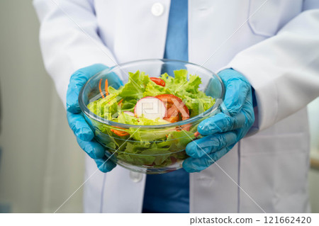 Asian Nutritionist holding healthy food for patient in hospital, nutrition and vitamin. 121662420