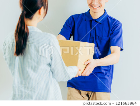 A courier driver delivering a package A courier driver delivering a package 121663964