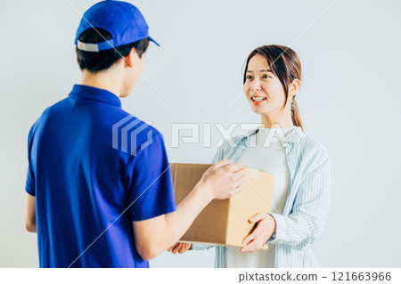 A courier driver delivering a package 121663966