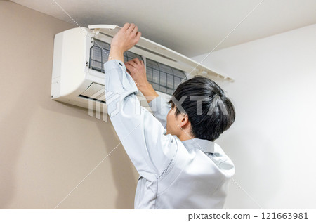 Workers inspecting air conditioners 121663981