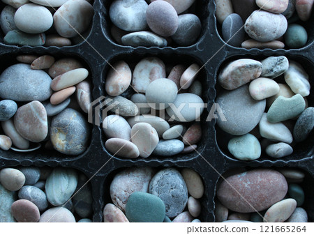 Pattern Of Symmetrical Partitions Of Cellular Tray Full Of Decorative Stones 121665264