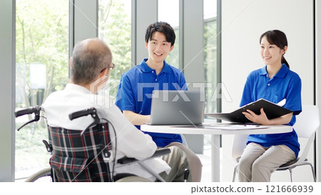 A caregiver explaining to an elderly person A caregiver explaining to an elderly person 121666939