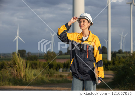 Female engineer wind turbine worker survey operational planning windmill clean renewable energy technology for future. Alternative technology protect environment reduce global warming problems. Female engineer wind turbine worker survey operational planning windmill clean renewable energy technology for future. Alternative technology protect environment reduce global warming problems. 121667055