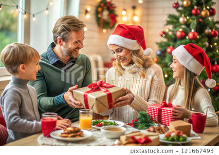 Family, winter holidays and people concept - happy caucasian family opening gift boxes at home on Christmas 121667493