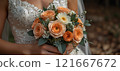 bride holding a wedding bouquet with roses 121667672