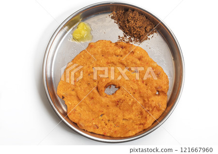 Traditional Indian dosa served with country sugar and ghee on a plate, top view 121667960