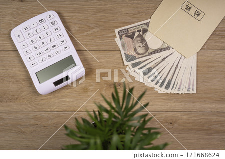 Calculating money at a desk on payday 121668624