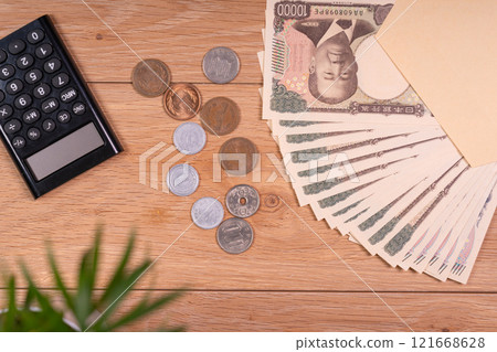 Calculating money at a desk on payday Calculating money at a desk on payday 121668628