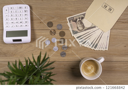 Calculating money at a desk on payday 121668842