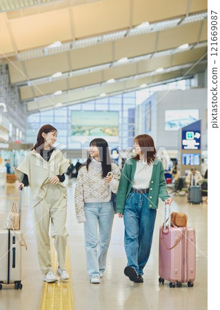 Woman walking in the airport Woman walking in the airport 121669087