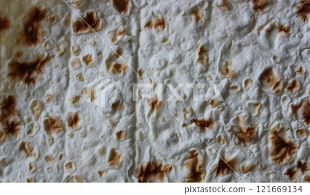 Pattern of sheet of thin pita bread for wrapping meat for shawarma or taco cooking Pattern of sheet of thin pita bread for wrapping meat for shawarma or taco cooking 121669134