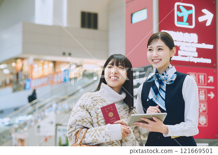 A woman receiving guidance from ground staff at the airport 121669501