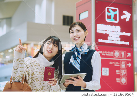 A woman receiving guidance from ground staff at the airport A woman receiving guidance from ground staff at the airport 121669504