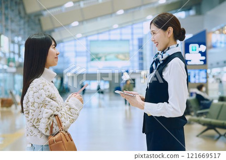 一名婦女在機場接受地勤人員的指導 121669517