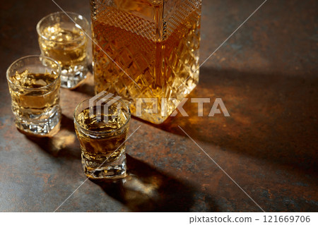 Decanter and small glasses of whiskey. Decanter and small glasses of whiskey. 121669706