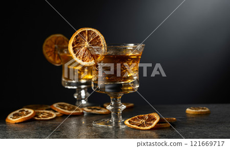Cocktails with rum or liqueur garnish with dried orange slices. Cocktails with rum or liqueur garnish with dried orange slices. 121669717