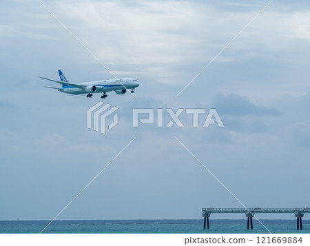 A landing passenger plane seen from Senaga Island A landing passenger plane seen from Senaga Island 121669884